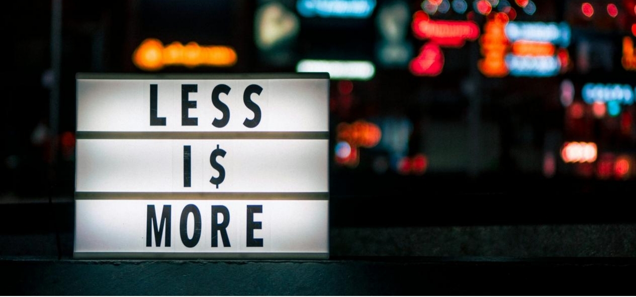 Sign that reads "Less is More," emphasizing budget-friendly choices.